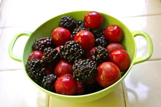 sugar plums and blackberries in colander