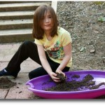 child playing in dirt